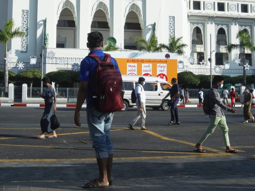 People walk past City Hall in Yangon on February 2, 2021, a day after Myanmar's military seized power in a bloodless coup, detaining democratically elected leader Aung San Suu Kyi and imposing a one-year state of emergency. People walk past City Hall in Yangon on February 2, 2021, a day after Myanmar's military seized power in a bloodless coup, detaining democratically elected leader Aung San Suu Kyi and imposing a one-year state of emergency.