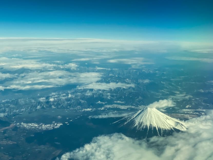 This aerial view of Mount Fuji, Japan's highest peak at 3,776 meters (12,388 feet), is seen from the window of a flight from Tokyo to Hong Kong, above Shizuoka Prefecture on March 1, 2024.