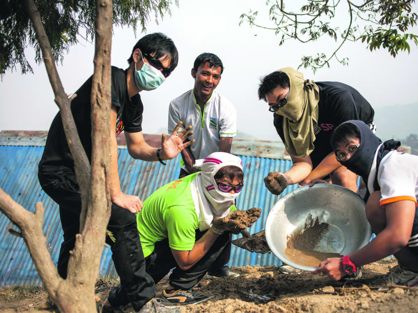 Project Nepal: Students with a metal dish used to transport raw materials for construction. Photo: Project NEPAL, YEP under NYC.