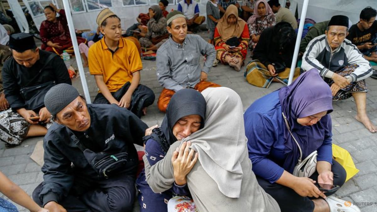 Relatives weep for scores of missing children after deadly Indonesia school collapse