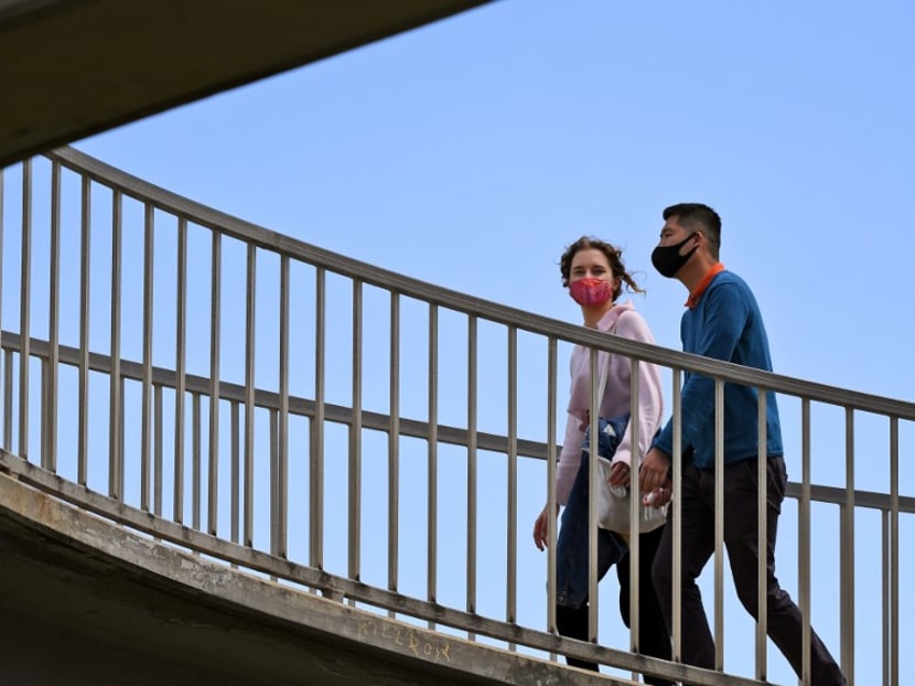 People wearing face masks cross a pedestrian bridge in the Melbourne suburb of St Kilda on Oct 26, 2020 as Australian health officials reported no new coronavirus cases or deaths in Victoria state, which has spent months under onerous restrictions after becoming the epicentre of the country's second wave. People wearing face masks cross a pedestrian bridge in the Melbourne suburb of St Kilda on Oct 26, 2020 as Australian health officials reported no new coronavirus cases or deaths in Victoria state, which has spent months under onerous restrictions after becoming the epicentre of the country's second wave.