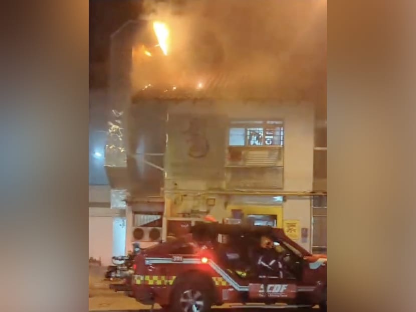 A photograph taken from a TikTok video posted by user sgjeff007 showing a fire at a coffee shop in Yishun.