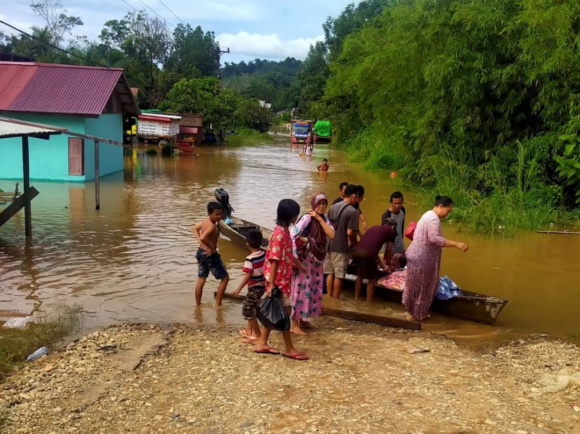 Villagers evacuating after a storm hit the Kapuas Hulu regency in West Kalimantan, inundating nearly 50 villages, destroying homes and other buildings and affecting nearly 15,000 residents on July 15, 2021.
