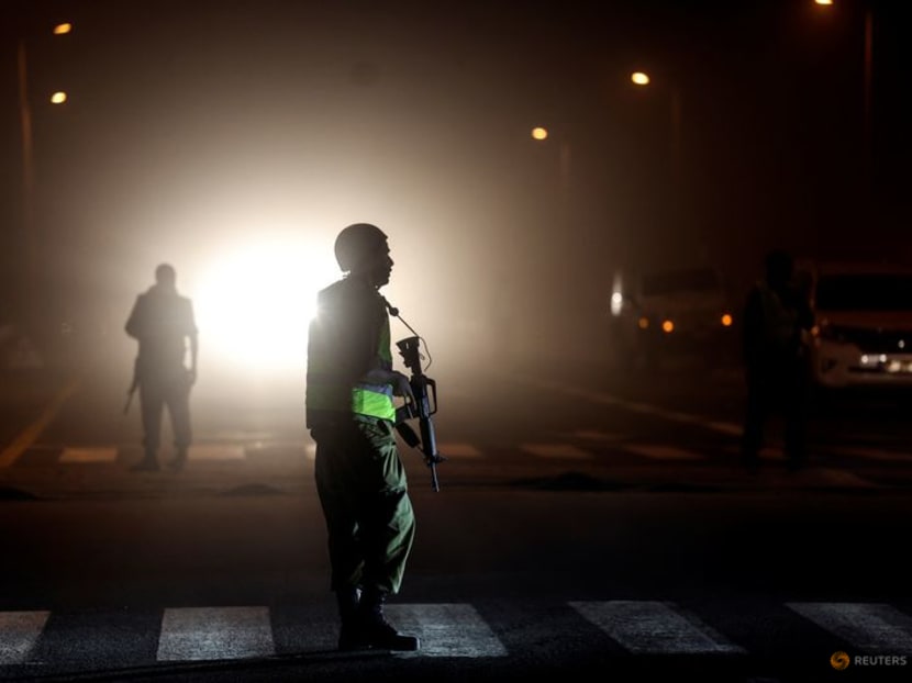 An Israeli soldier is silhouetted on a road near Israel's border with the Gaza Strip, in southern Israel, October 12, 2023. REUTERS/Ronen Zvulun