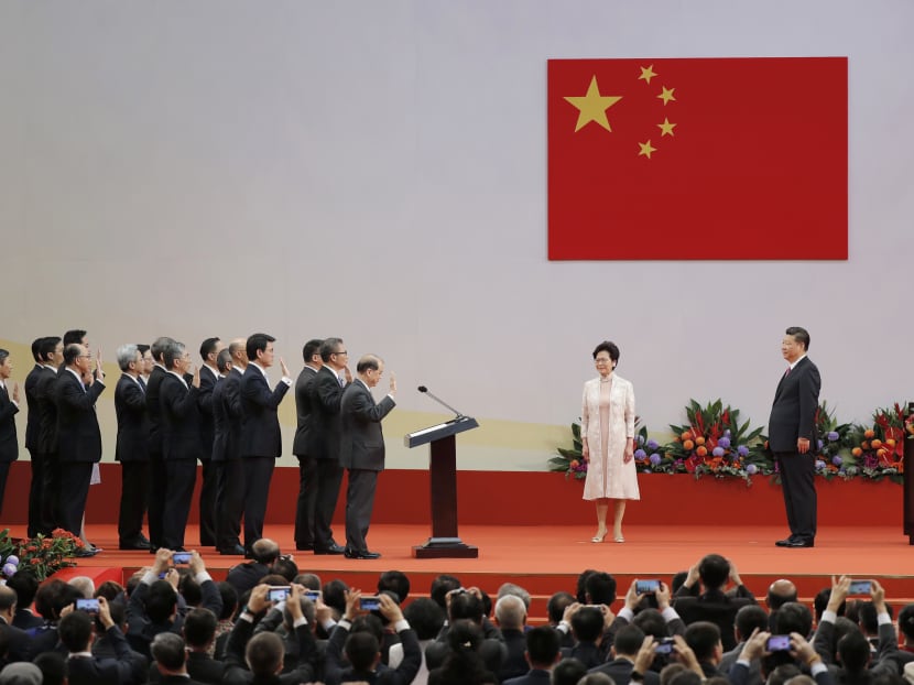 Chinese President Xi Jinping, right, administers the oath to Hong Kong's new Chief Executive Carrie Lam's new cabinet  in office at the Hong Kong Convention and Exhibition Center Saturday, July 1, 2017.  Photo: AP
