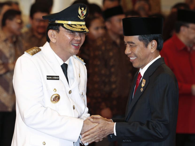 Jakarta Governor Basuki Tjahaja Purnama (left) is greeted by Indonesia's President Joko Widodo after his swearing-in at the Presidential palace in Jakarta yesterday. Photo: Reuters