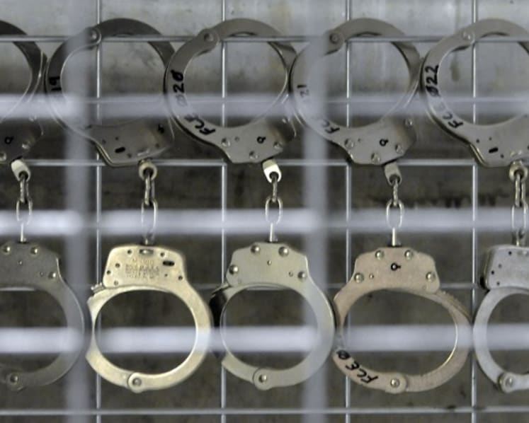 Two former prison officers charged after sharing confidential information with inmate