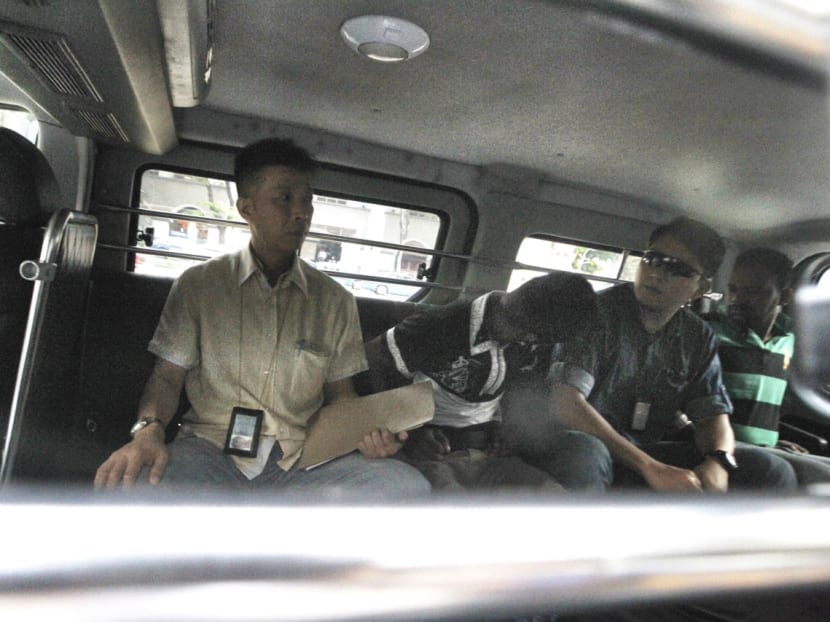 The suspects (second and fourth from left) arriving at the State Courts under police custody. Photo: DON WONG