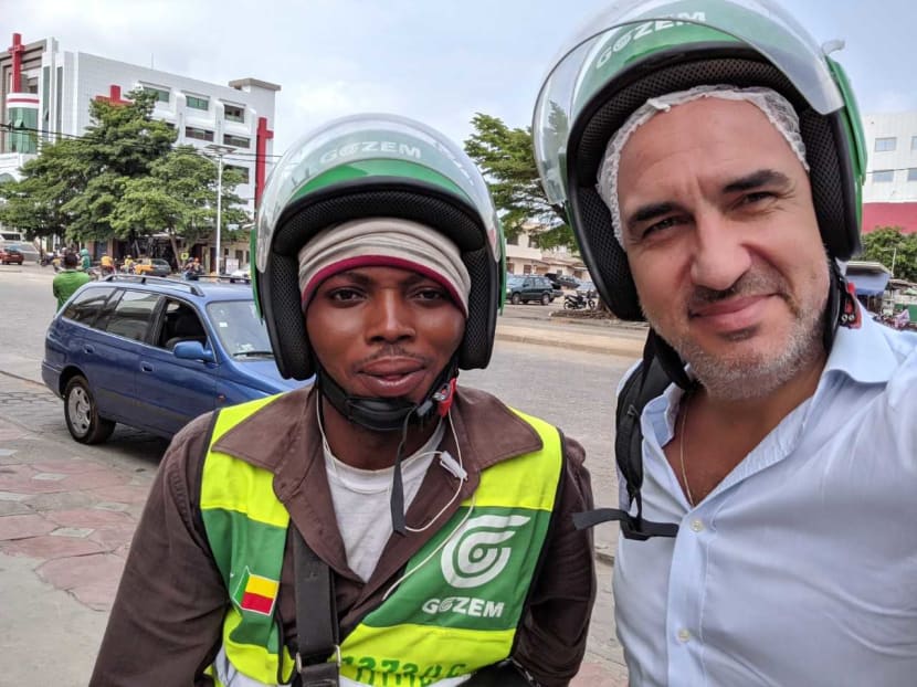 Singapore-based Swiss expat, Mr Raphael Dana (right), in the West African nation of Benin with a driver who has signed up with the start-up he co-founded called Gozem. Singapore-based Swiss expat, Mr Raphael Dana (right), in the West African nation of Benin with a driver who has signed up with the start-up he co-founded called Gozem.