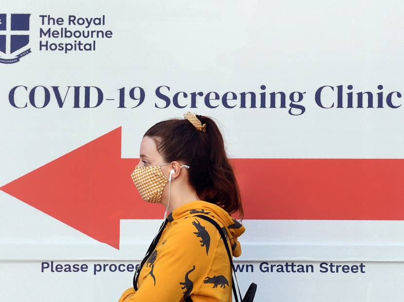 A woman queues outside a Covid-19 testing venue at The Royal Melbourne Hospital in Melbourne on July 16, 2020. A woman queues outside a Covid-19 testing venue at The Royal Melbourne Hospital in Melbourne on July 16, 2020.