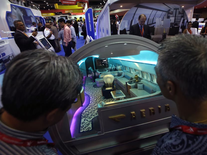 Visitors look into a mock up of a luxury cabin interior on display during the Singapore Airshow at Changi Exhibition Centre, Feb 17, 2016.  Photo: Reuters