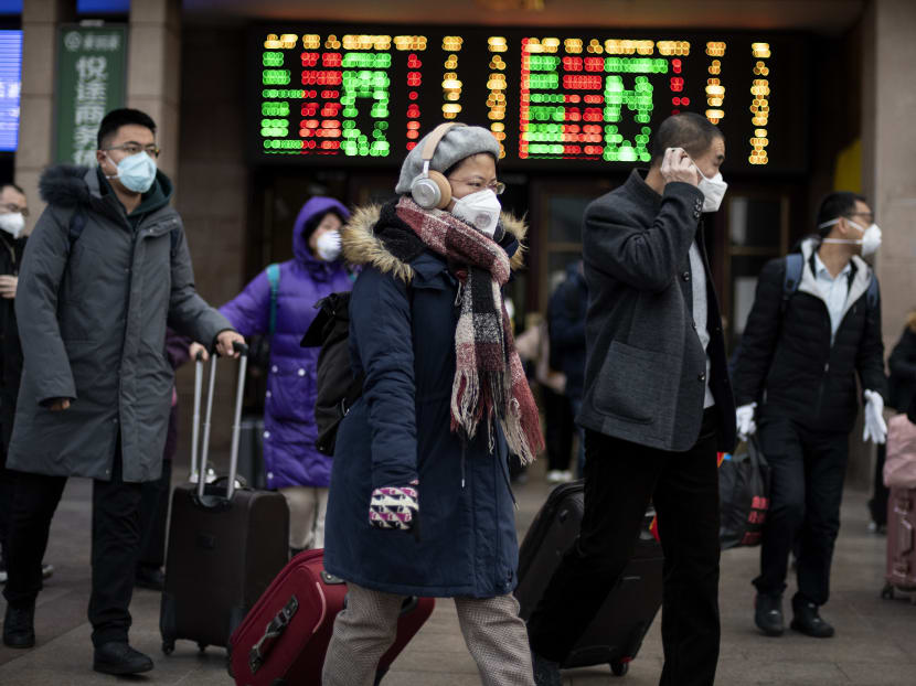 Passengers wearing facemasks arrive from different provinces at the Beijing Railway Station on February 1, 2020.