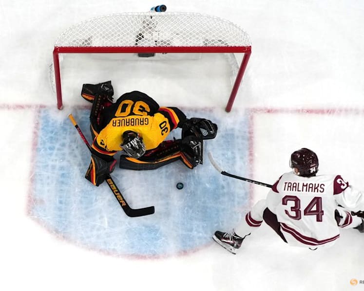 Ice hockey-Slovakia win group, US beat Denmark, Finland, Latvia notch wins
