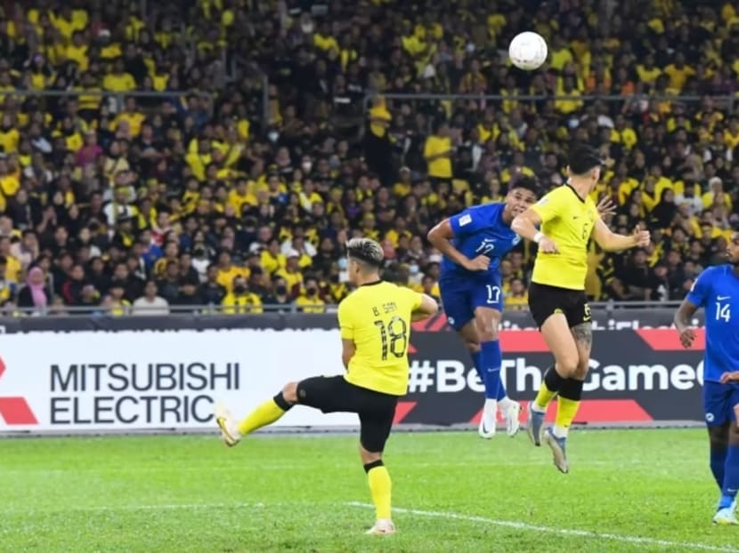 Singapore's Irfan Fandi leaps for a header.