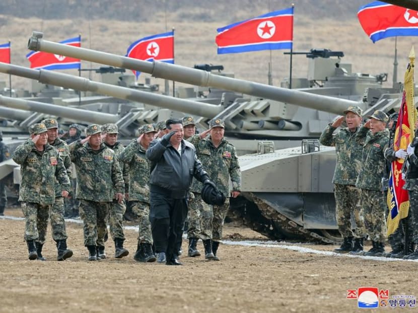 North Korean leader Kim Jong Un salutes as he guides a military demonstration involving tank units, in North Korea, March 13, 2024 in this picture released on March 14, 2024, by the Korean Central News Agency.  KCNA via REUTERS