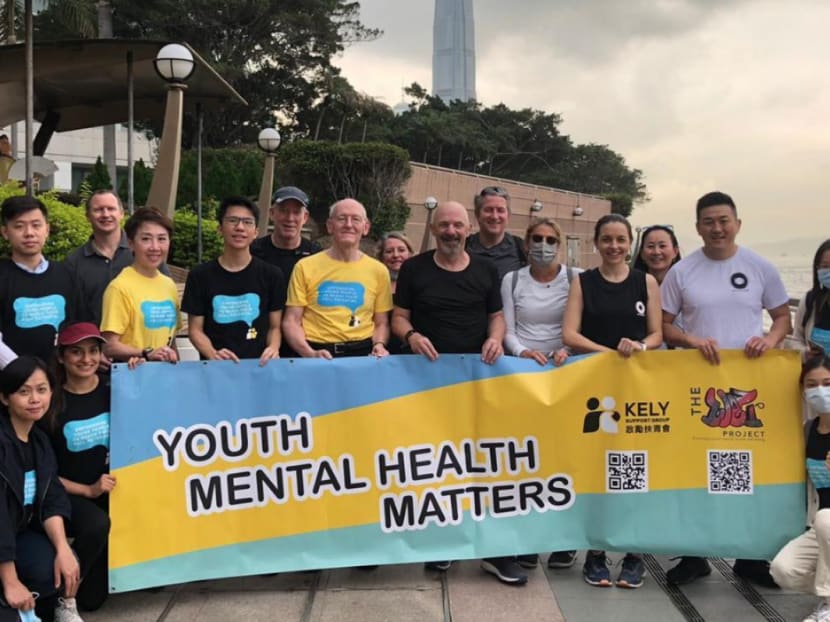 Mr Tony Bruno (black shirt, centre) is pictured with supporters in Wan Chai. Mr Bruno walked 62 kilometres in just under 13 hours around Hong Kong Island to help raise money for suicide awareness.