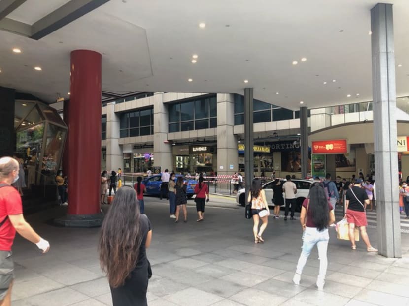 People turned away from Lucky Plaza on May 2, 2021 wait for their friends who managed to enter.