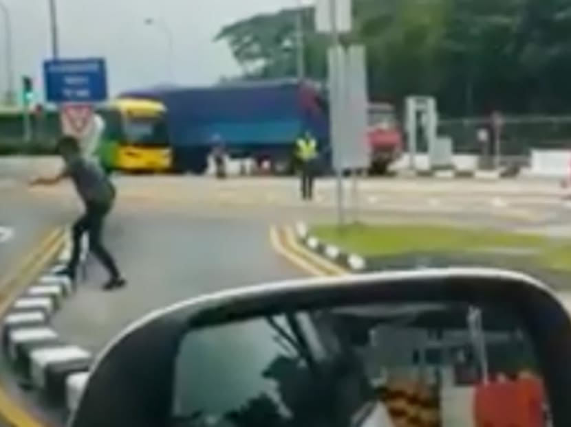 Chew Guan Mong (second from left) was arrested in January 2018, after he had a standoff with law enforcement and security personnel at Woodlands Checkpoint. Images of the incident were posted on social media.
