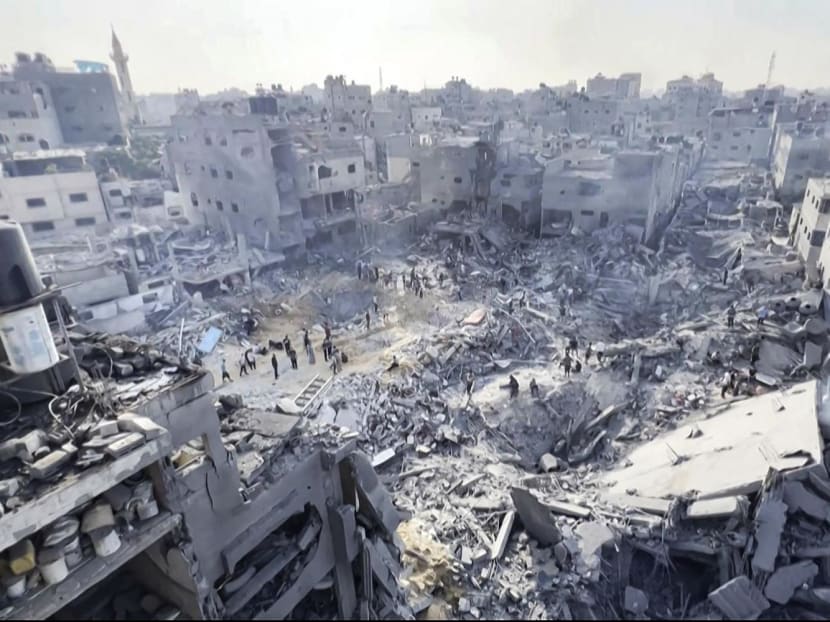This image grab taken from AFPTV video footage shows Palestinians checking the destruction in the aftermath of an Israeli strike on the Jabalia refugee camp in the Gaza Strip, on Nov 1, 2023, amid ongoing battles between Israel and the Palestinian Hamas movement.