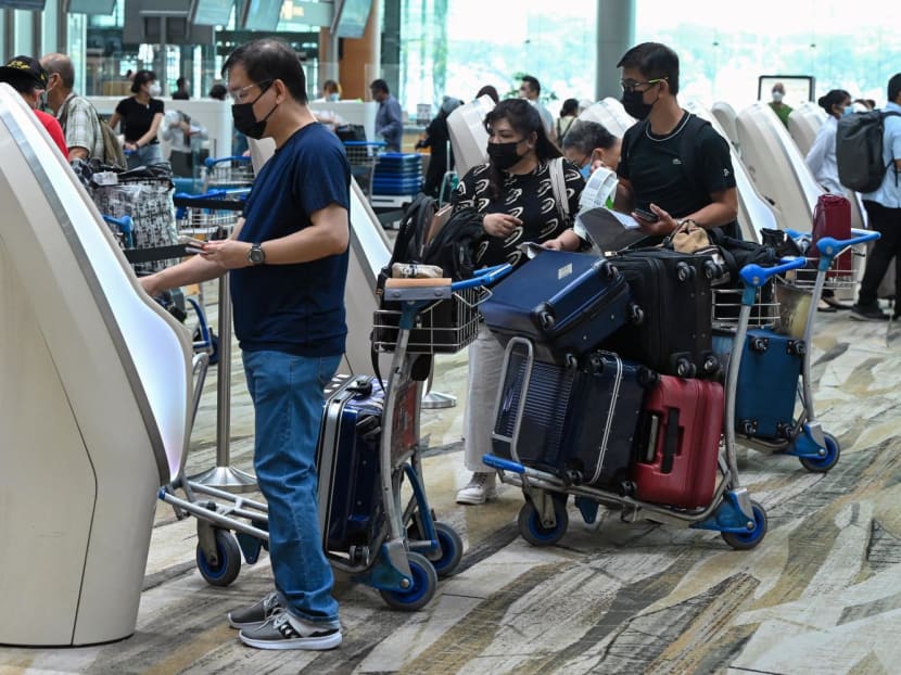 Travellers register for self check-in before departure at Singapore Changi Airport in Singapore on April 1, 2022. Travellers register for self check-in before departure at Singapore Changi Airport in Singapore on April 1, 2022.