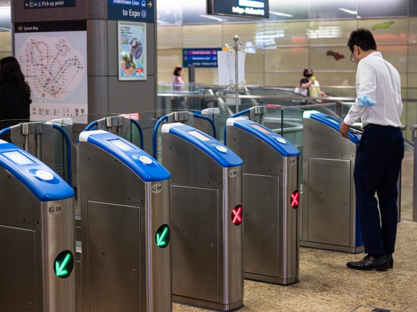 A commuter tapping at an MRT fare gate on Jan 12, 2024. A commuter tapping at an MRT fare gate on Jan 12, 2024.