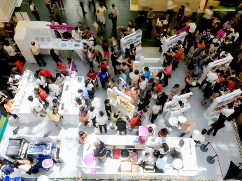Members of public visiting and asking questions of the SkilllsFuture Credit and courses and on the first day of the 3-days roadshow of SkilllsFuture Marketplace at One Raffles Place Atrium in February last year. TODAY file photo.