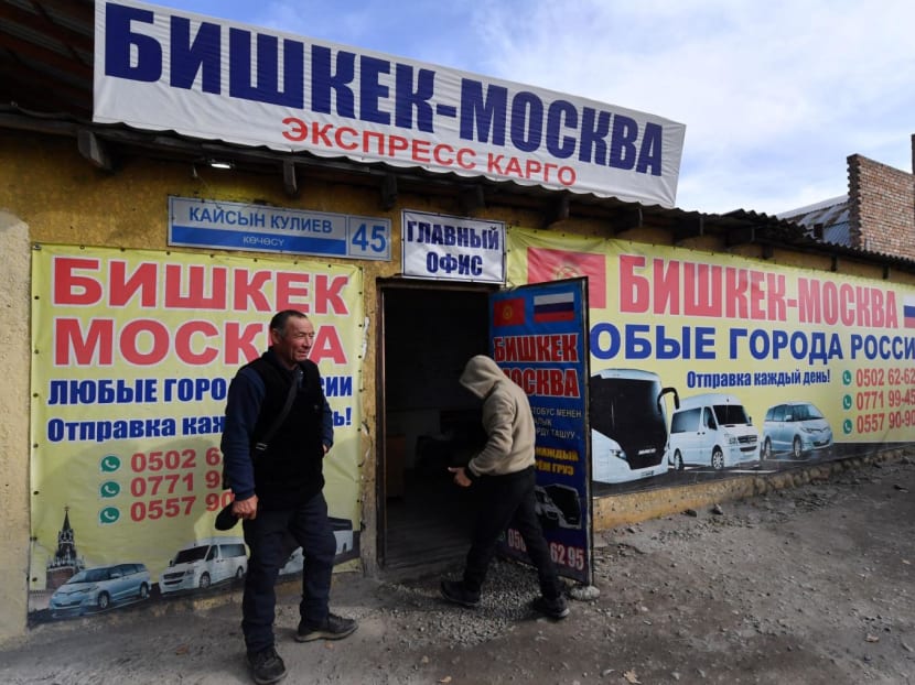 Kyrgyz male labor migrants wait to leave to work in Russia at the office of a company organizing passenger transportation to Russia in Bishkek on Oct 17, 2023.