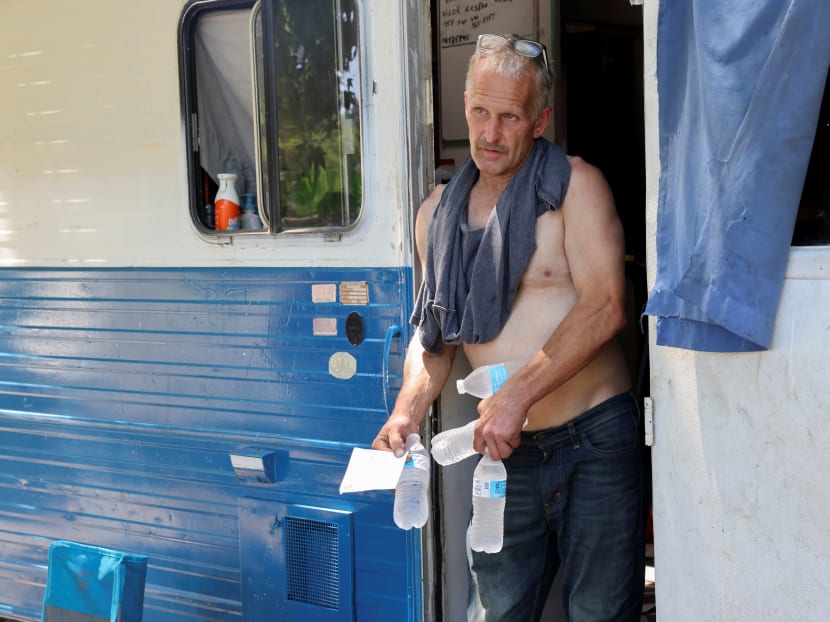 A man talks with volunteers from the Salvation Army Northwest Division who gave him bottled water during a heat wave in Seattle, Washington, United States on June 27, 2021. A man talks with volunteers from the Salvation Army Northwest Division who gave him bottled water during a heat wave in Seattle, Washington, United States on June 27, 2021.