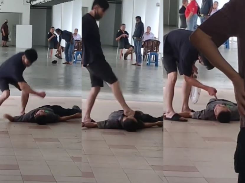 In videos that have surfaced online, a man in a dark-coloured T-shirt can be seen raining blows on another man who was unresponsive on the ground. In videos that have surfaced online, a man in a dark-coloured T-shirt can be seen raining blows on another man who was unresponsive on the ground.