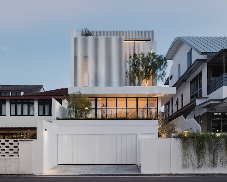 Behind the mysterious white facade of this Singapore house lies a warm, light-filled home