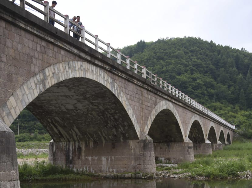 The wreckage of a bus at the site of the road accident on Ji'an-Dandong Road in Ji'an City, north-east of China's Jilin Province, is shown in this photo released by China's Xinhua News Agency, on July 2, 2015. Photo: Xinhua/AP