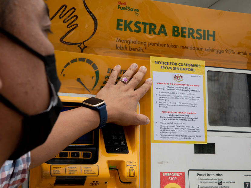 A sign at a petrol station in Johor Baru reminding Singaporeans that the purchase of RON95 petrol is prohibited.
A sign at a petrol station in Johor Baru reminding Singaporeans that the purchase of RON95 petrol is prohibited.