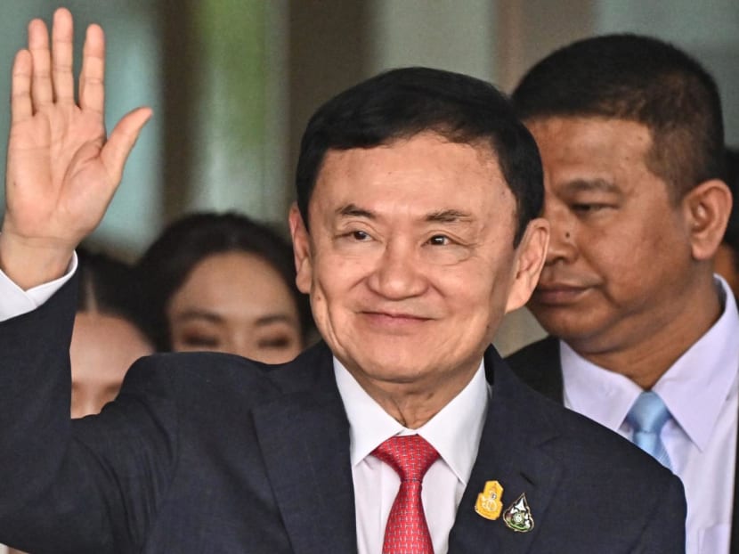 Former Thai Prime Minister Thaksin Shinawatra greets his supporters after landing upon return from self-exile at Bangkok's Don Mueang airport on Aug 22, 2023.