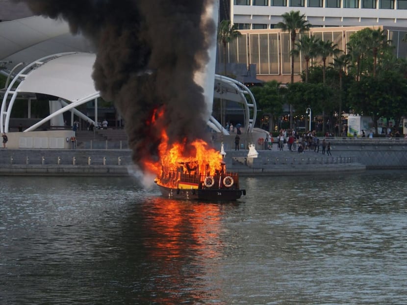 The boat on fire in Marina Bay on July 12. Photo submitted by TODAY reader Luke.