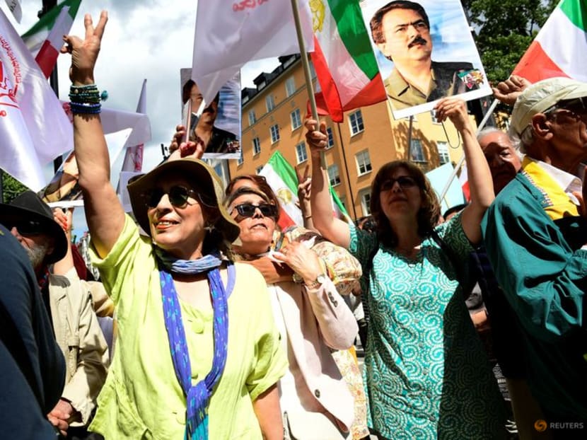 People react to the verdict of the trial of Hamid Noury, a former Iranian prosecution official accused of crimes against international law and murder in Iran in 1988, outside the Stockholm District Court in Stockholm, Sweden July 14, 2022. Noury was sentenced to a lifetime in prison. Chris Anderson/TT News Agency/via REUTERS/File Photo