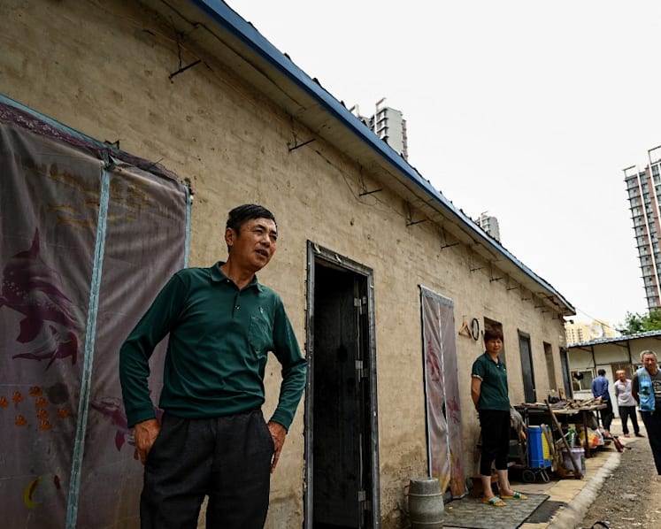 China signals it will relax household registration restrictions