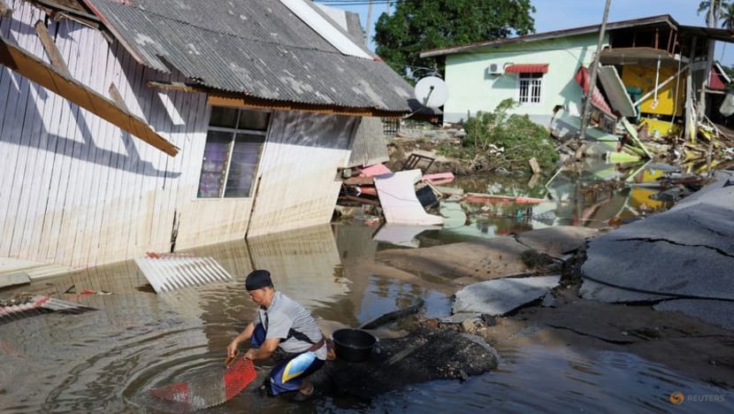 Clean-up begins in Malaysia towns hit by six months of rain in five days