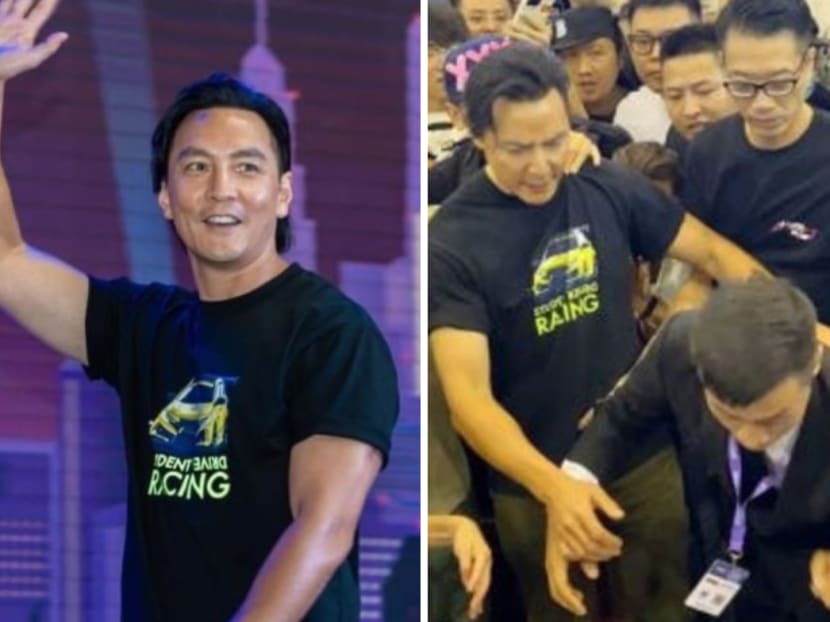 Daniel Wu saves fan pushed over by crowd at auto show, also prevents potential stampede