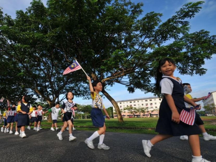 School children in Malaysia waving the national flag.  Chinese education in Malaysia marks its 200th anniversary next year.