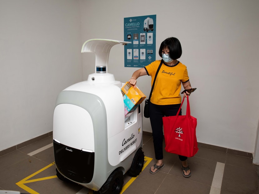 Ms Christine Chong, a resident in Punggol Drive, collecting her groceries at the delivery point for the Camello robot, located at the void deck of the housing block. Ms Christine Chong, a resident in Punggol Drive, collecting her groceries at the delivery point for the Camello robot, located at the void deck of the housing block.