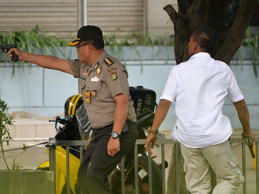 Seven dead in Jakarta blasts, gunfight