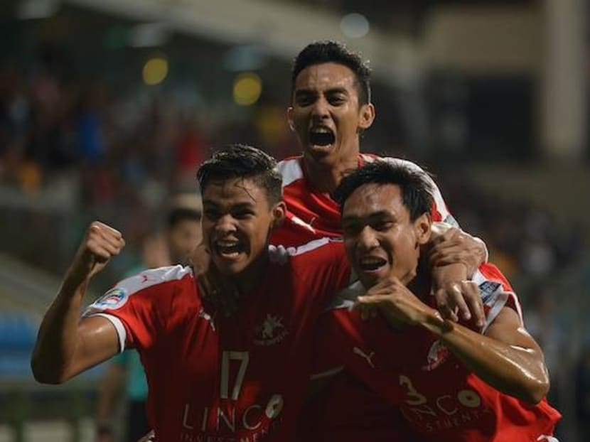 Home United's Irfan Fandi (left), Faris Ramli (centre) and Afiq Yunous celebrating a goal against Myanmar's Yadanaborn in an AFC Cup group game. The Protectors have qualified for the quarter-finals of the competition. Photo: AFC CUP Facebook page