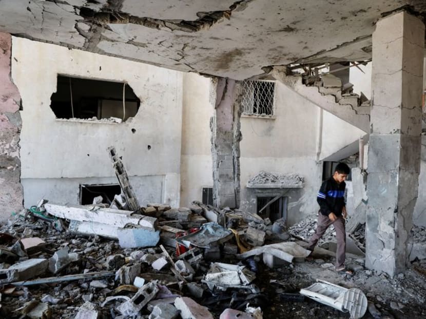 A Palestinian boy checks the damage at a mosque which was hit in an Israeli air strike, in Jenin refugee camp in the Israeli-occupied West Bank on Oct 22, 2023.