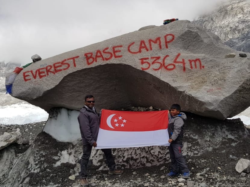 Darrshan Raj Thurairajasingam, 8, and his father Mr Thurairajasingam Vijeyasingam, 37, reach Everest base camp in Nepal on June 14, 2019. The trek is tough even for adults, but even more so for children.