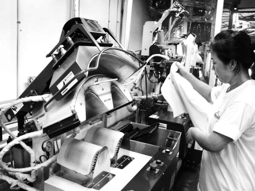 Workers at Presto Drycleaners production plant using automation for some of their operations. As the backbone of Singapore’s economy, SMEs must take the first step towards sustainable progress in an increasingly competitive and unpredictable economy. TODAY file photo