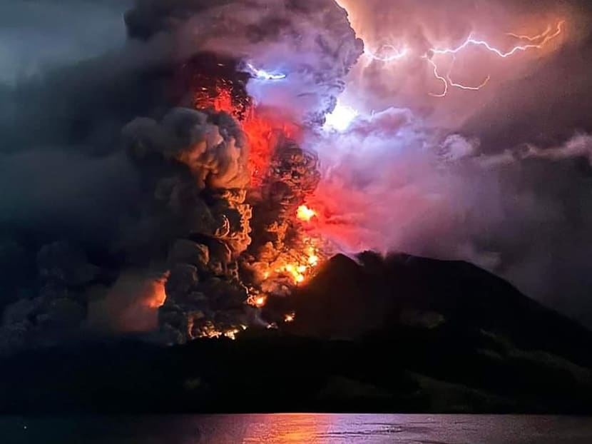 This handout photograph taken and released by the Center for Volcanology and Geological Hazard Mitigation on April 17, 2024, shows Mount Ruang spewing hot lava and smoke as seen from Sitaro, North Sulawesi. This handout photograph taken and released by the Center for Volcanology and Geological Hazard Mitigation on April 17, 2024, shows Mount Ruang spewing hot lava and smoke as seen from Sitaro, North Sulawesi.