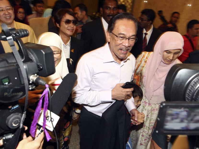 Malaysian opposition leader Anwar Ibrahim (centre) smiles as he arrives at the court house in Putrajaya, Malaysia on Feb 10, 2015.  Photo: AP
