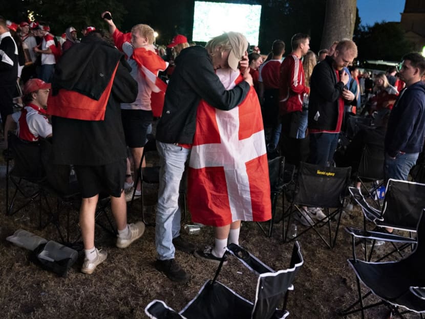 Danish football fans comfort each other at Kildeparken in Aalborg after Denmark was defeated by 2-1 in the Uefa Euro 2020 semi-final football match between England and Denmark on late July 7, 2021. Danish football fans comfort each other at Kildeparken in Aalborg after Denmark was defeated by 2-1 in the Uefa Euro 2020 semi-final football match between England and Denmark on late July 7, 2021.