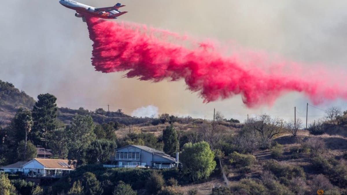 Aerial assault aims to stem LA Palisades fire eastward spread