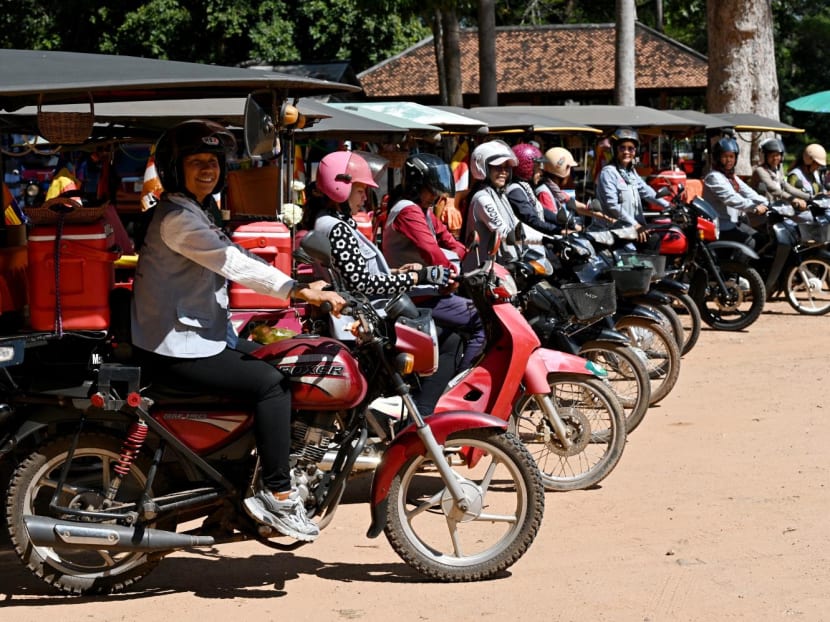 This photo taken on Nov 17, 2023 shows female Tuk Tuk drivers waiting for their passengers near the terrace of the elephants at the Angkor complex in Siem Reap province.